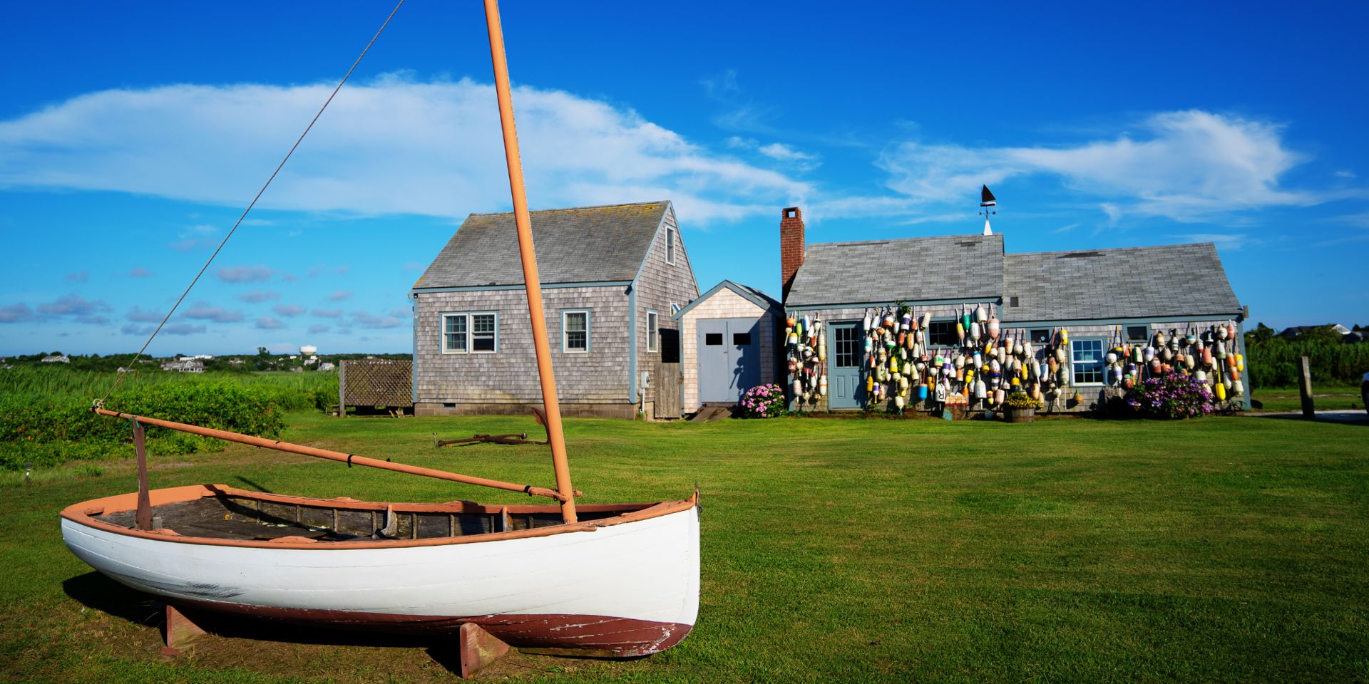 A Nantucket cottage with a classic dory on the lawn